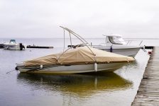 boat-covered-with-beige-tarpaulin-harbor-lacanau-lake-port-france-min